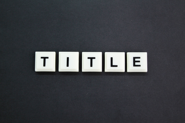 3D word title in black on white squares stands for how to write title tags.