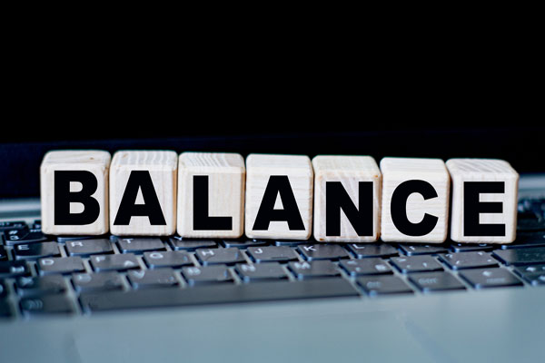 3d wooden blocks spelling out the word balance on keyboard stands for keyword placement.
