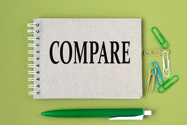 Pen and binder with compare text on it.