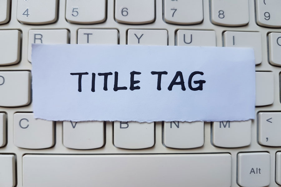 Title tag text on note on top of computer keyboard.