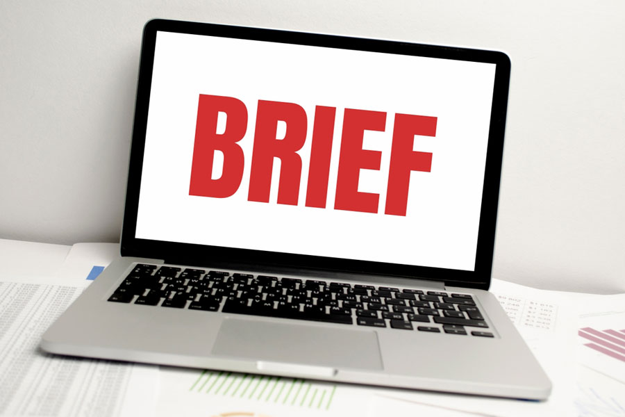 Laptop computer with word brief on screen.