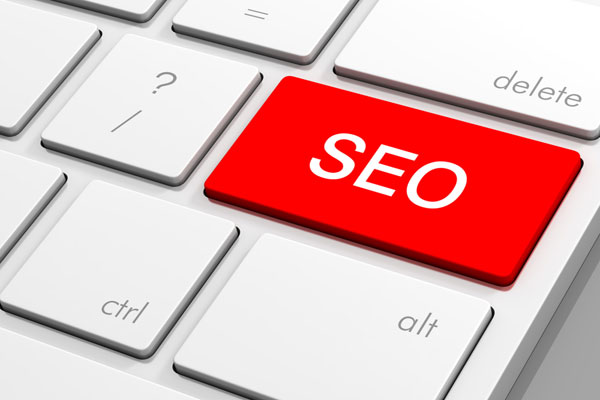 Computer keyboard with SEO text on key.
